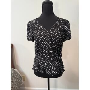 Tamara H. black polka dot wrap top with peplum hem